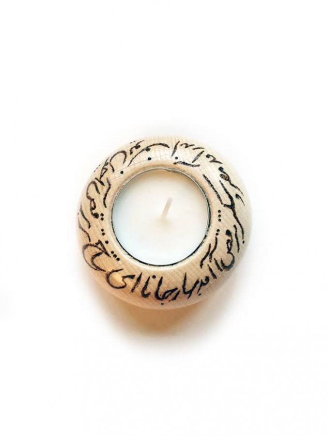 Norouz poem written on wooden candle base by burning it