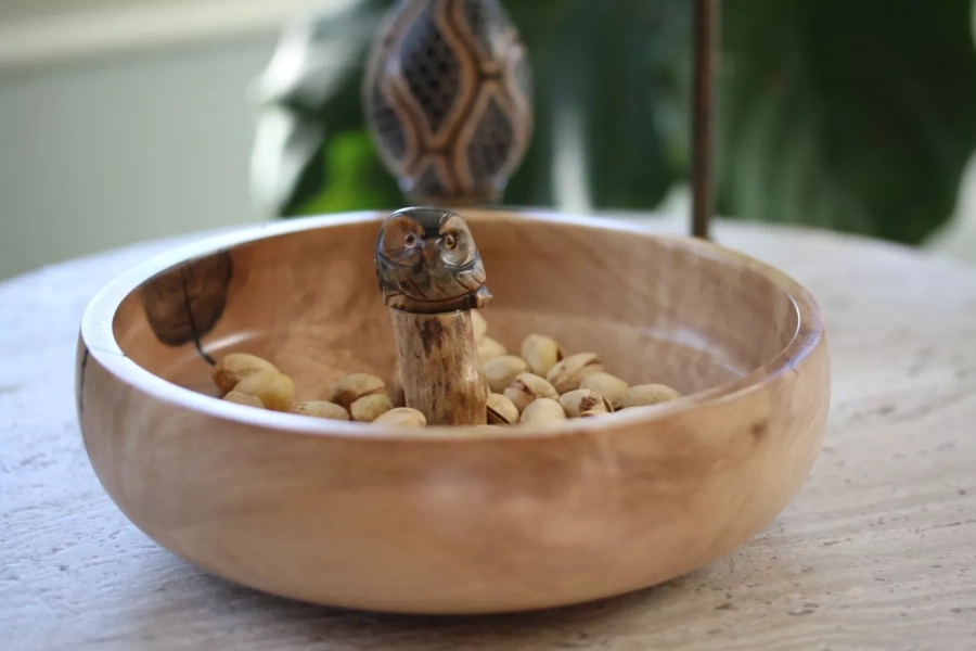 Wooden nuts bowl with stone owl